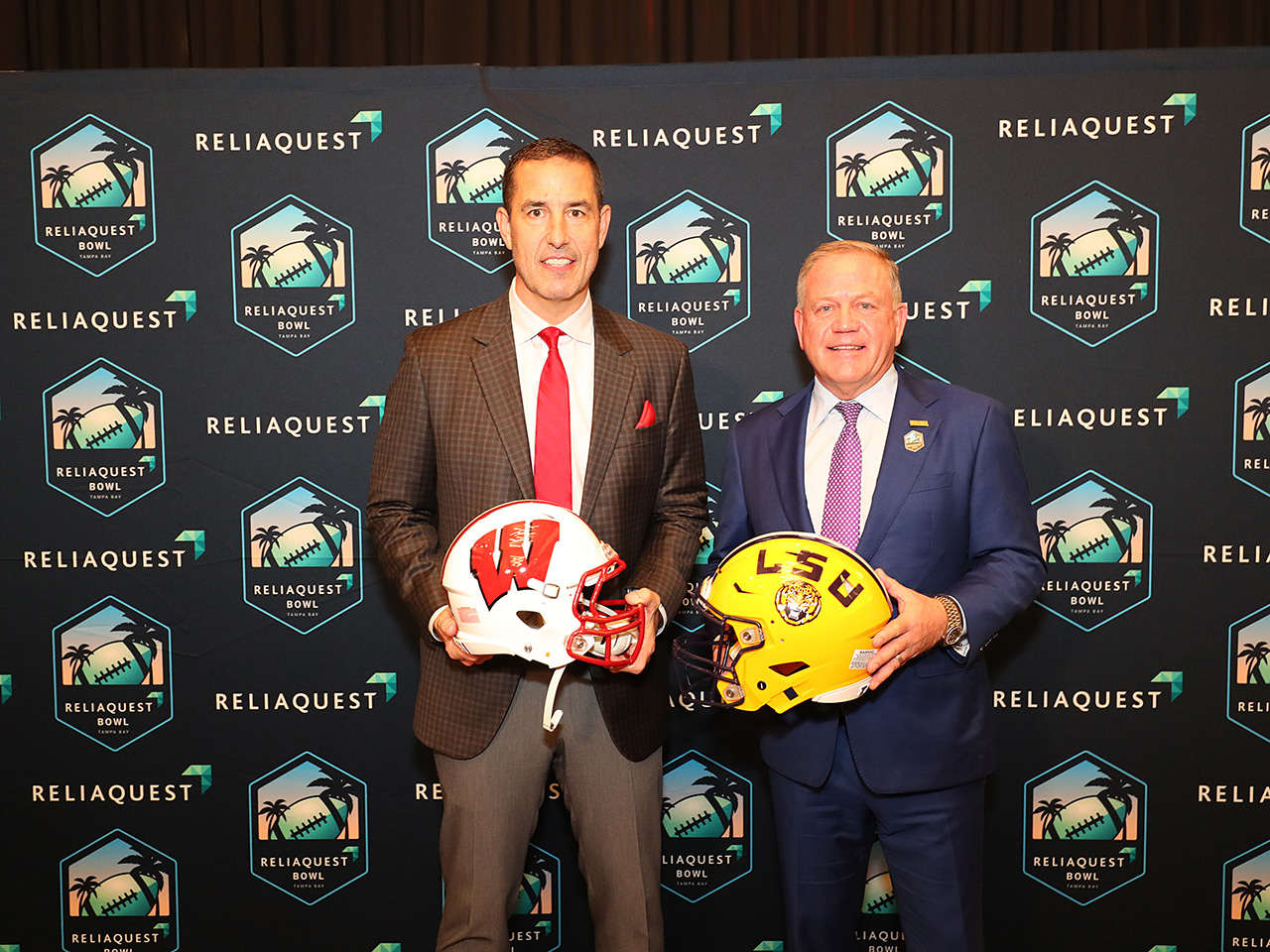 The Coaches pose with their helmets