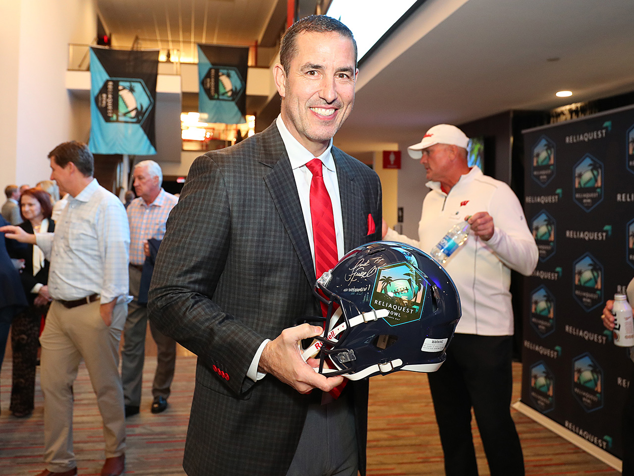 Coach Fickell signs a Bowl Helmet for a lucky guest