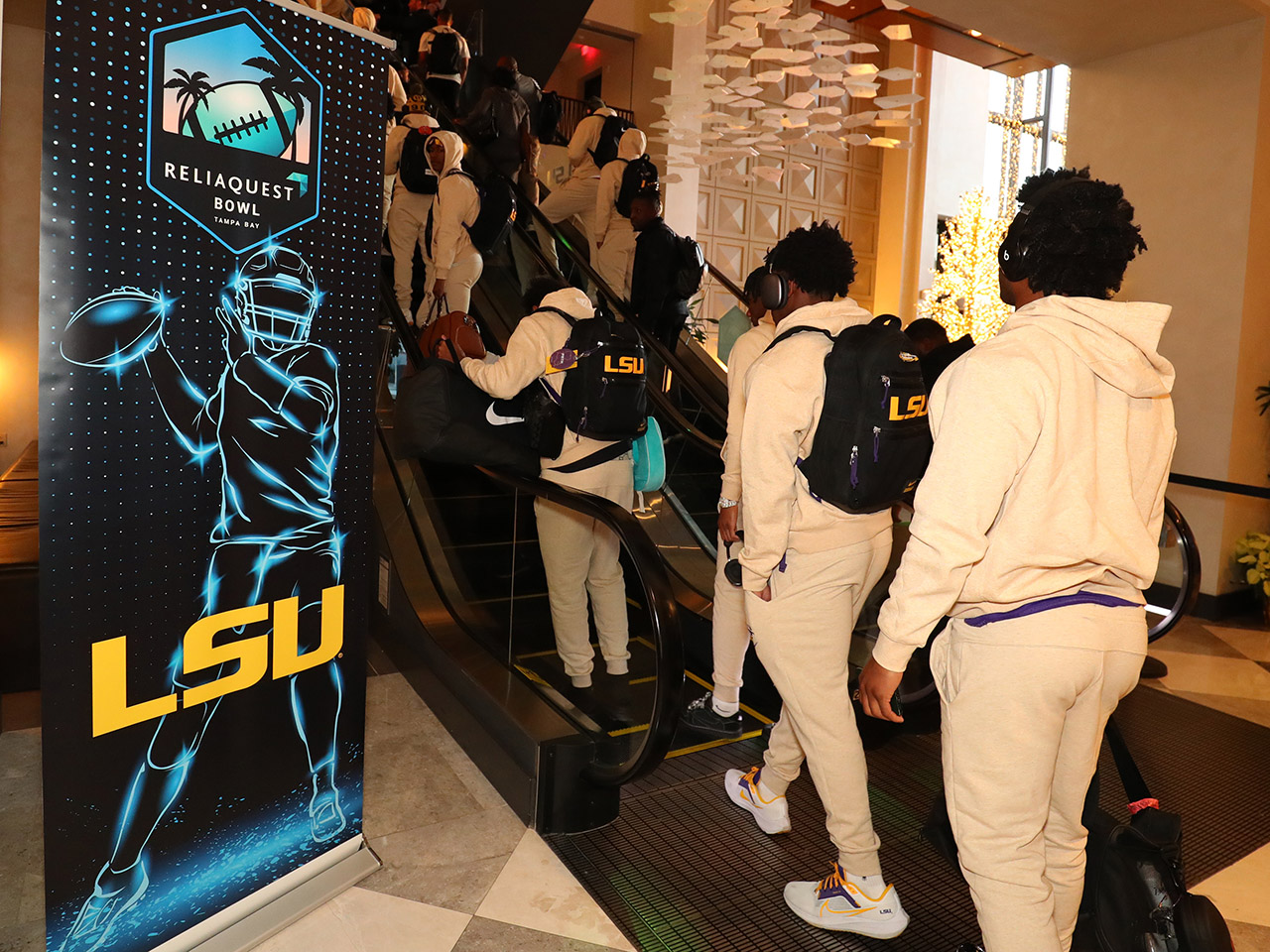 Players arrive at the JW Marriott Tampa Water Street to prepare for the ReliaQuest Bowl